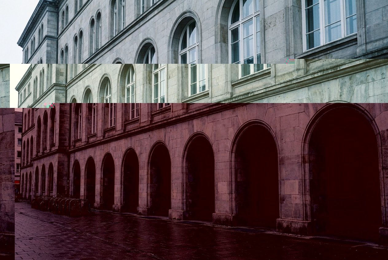 Steinerne Fassade mit Arkadengang eines Handelsviertels an einem bewölkten Morgen